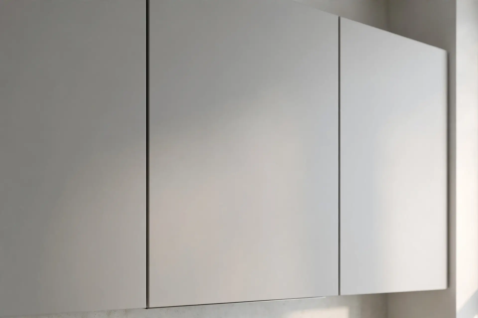 Close-up of modern handleless matte kitchen cabinet fronts with clean seamless lines